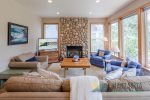 Seating for all in front of the tv, gas fireplace, and nature views.